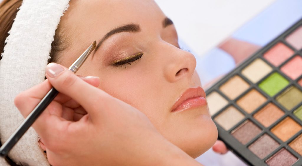 Beautiful Woman Having Make Up Applied by Beautician at Spa